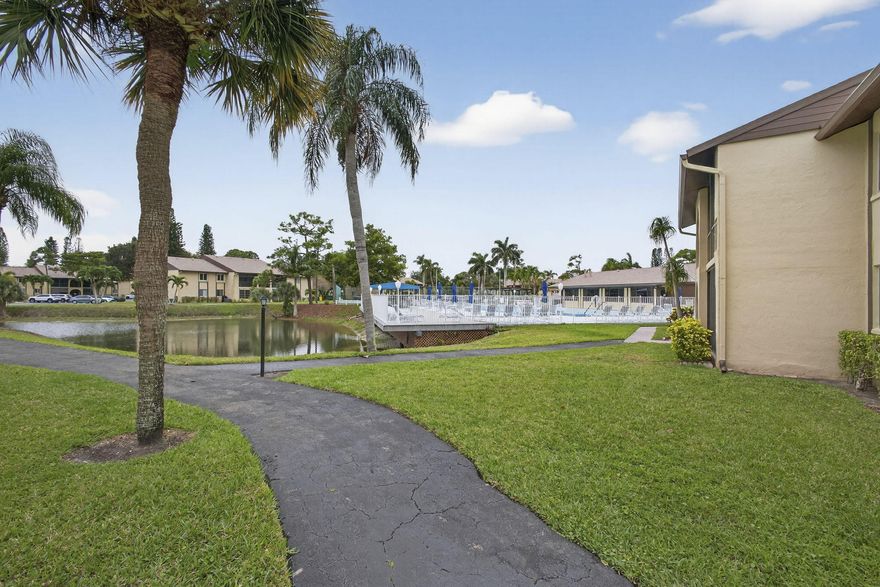 Welcome to Pine Ridge III, a vibrant 55+ no-pet community. Residents enjoy a clubhouse, sparkling pool, shuffleboard, bocce, and pickleball courts, with a scenic lake, complete with a walking trail. This first-floor, corner-unit condo features 2 beds and 1.5 baths ready for a new owner. Seasonally owned and well-maintained, the home includes a dedicated parking space just steps from your front door. Along with a screened patio with a view of the pool area located across the street. Inside, the condo boasts laminate flooring, updated kitchen, and the convenience of an in-unit washer/dryer. Both bedrooms offer spacious walk-in closets, and bathrooms have been tastefully updated, providing comfort and modern appeal.