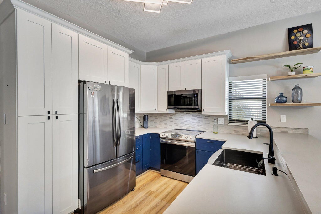 Photo of 13005 MEADOWBREEZE Drive, Wellington, FL 33414 (MLS # B26093142)