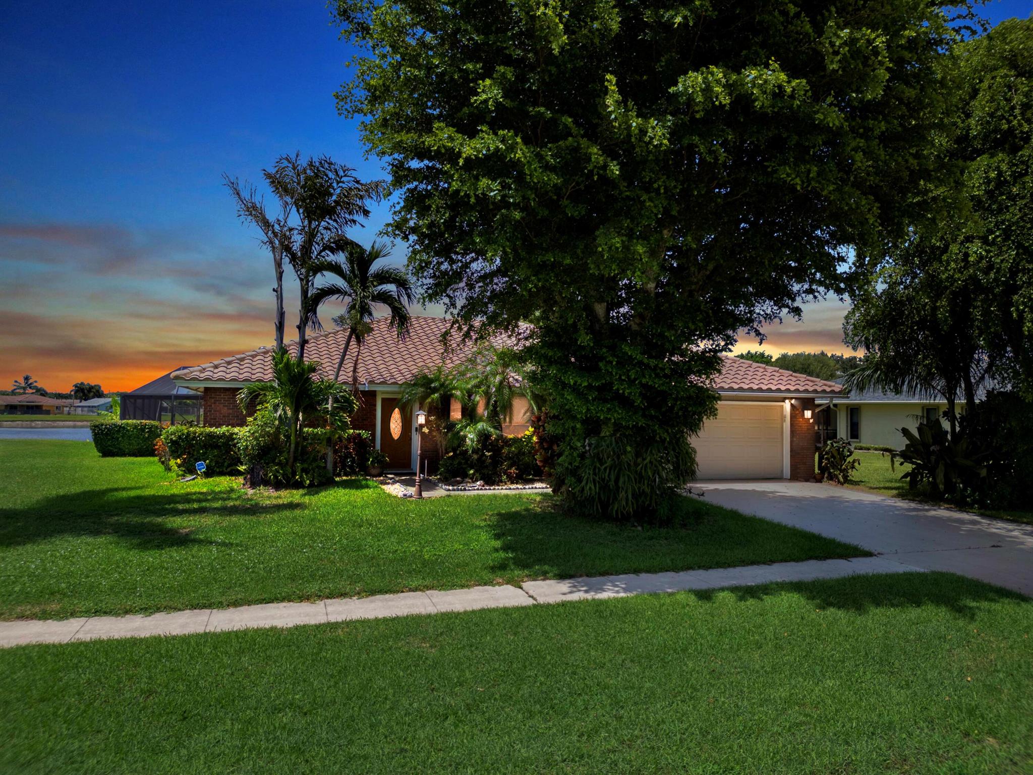 Discover this beautiful single-family pool home perfectly situated on a tranquil lake in the highly sought-after Woodland Creek community. Offering 3 bedrooms, 2 bathrooms, a private office, and a 2-car garage, this spacious residence features an open split-bedroom floor plan with vaulted ceilings, a formal living and dining area, and a comfortable family room designed for both everyday living and entertaining. The kitchen overlooks the main living space and opens to a fully enclosed lanai, where you can relax and enjoy peaceful lake views year-round. Woodland Creek is admired for its A-rated schools, low HOA fees, and wonderful amenities including tennis, pickleball, a lakeside pavilion, and a play area. Ideally located near shopping, dining, nature preserves, and the National Polo