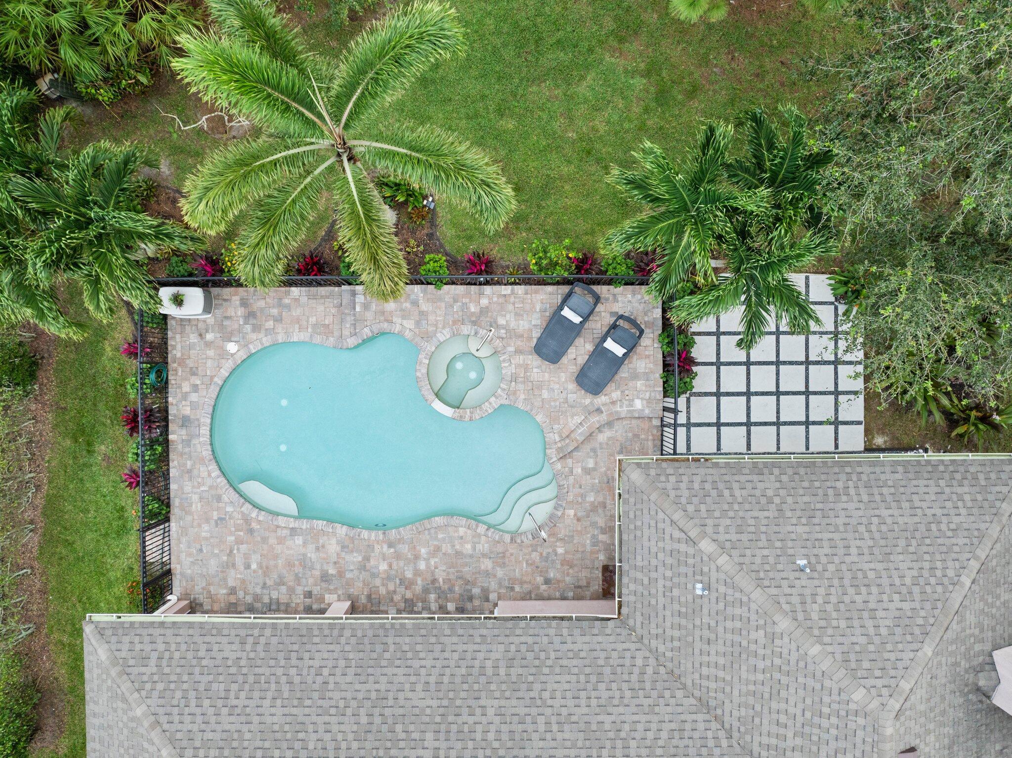 Stunning 4-bedroom, 3-bath, 3-Car Garage, Saltwater Pool/Spa home, beautifully remodeled, lots of extras! Welcome to the Estates at Windy Pines, a serene, well-maintained community in St. Lucie West's coveted Torino area. Fall in love w lush tropical landscaping, a saltwater pool, a heated jacuzzi w spacious paver-tiled areas perfect for entertaining! Inside, enjoy volume ceilings, updated quartz counters, 42'' cabinets, & coastal hues throughout. The flexible floor plan is ideal for multi-generational living. Primary areas open to the pool, w electric screens for seamless indoor-outdoor living. New roof, AC, & water heater (2025) & low HOA fees ($64/month). Close to schools, shopping, restaurants, parks w amenities like pickleball & dog parks