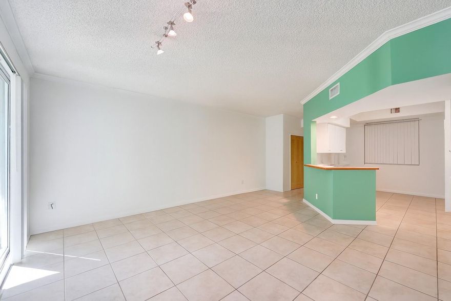 Furniture has been removed since pictures were taken. This first floor unit offers the perfect blend of comfort and convenience. New flooring, New A/C, thoughtfully designed closet system in the primary bedroom. Accordion shutters installed on all windows. Step outside to a private patio area, ideal for morning coffee or evening relaxation. The kitchen features a new refrigerator and an in unit full washer and dryer. Community amenities feature three sparkling pools, a clubhouse, gym, sauna, tennis courts and beautiful views of the bay. Renting is allowed in this community.