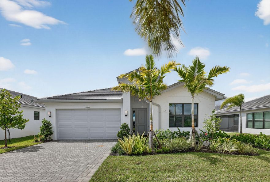 Best priced lakefront home in Valencia Walk with views from almost every room!  Features a decorator's white kitchen with a huge island, pull out storage, gas range and granite counter tops with a custom back splash.  Meander out to your extended patio with a built in gas stub and a Weber grill waiting for your evening barbecues. This Ibis model was built in 2024 and features a split bedroom plan with a den that could easily become a third bedroom.  Easy living features include oversized white porcelain flooring, a two car garage, and hurricane impact windows throughout making this a perfect year round home or vacation retreat conveniently located just a short drive to PBI or Vero Beach Airports. This home can be sold Furnished or Unfurnished and a golf cart is available to go with the sale as well! Enjoy access to the brand-new 34,000 sq ft clubhouse, boasting a grand social hall, state-of-the-art fitness center, card rooms, a café with indoor and outdoor dining, a resort-style pool, a covered patio with a fire pit, a sports lounge, and a full-time lifestyle director dedicated to enhancing your experience. Riverland, a 4,000-acre master-planned community, offers an unparalleled lifestyle. Residents enjoy a 16-acre Sports & Racquet Club, a 51,000 sq ft Wellness & Fitness Center, a 5-acre Arts & Culture Center with an 11,550 sq ft Creativity Hub, multiple city parks, and a future Town Center, making this an exceptional place to call home.