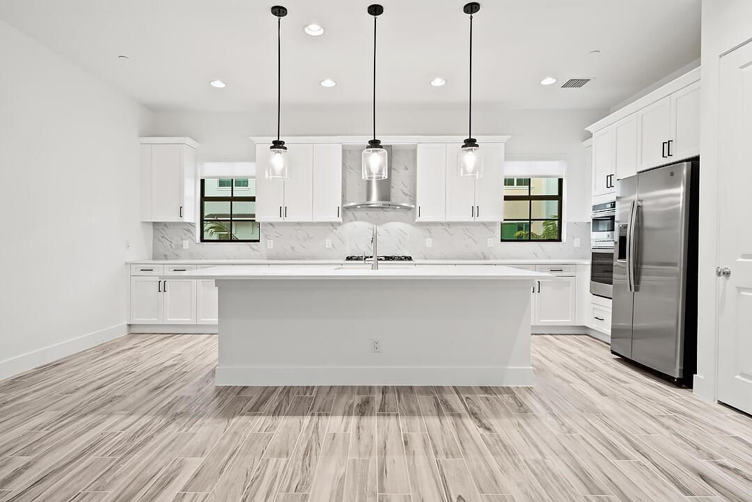 OFFERING FREE RENT FOR THE MONTH OF DECEMBER WITH DECEMBER MOVE IN. Brand new construction in the newest phase of Alton. This light bright never before lived in 3 bedroom + den/3.5 bath townhouse has decorator window treatments throughout, and new lighting fixtures in every room. Open modern concept kitchen living area with oversized kitchen island. Rental price also includes cable and high speed internet. Walk right to the JCC, dog park, town center, and community clubhouse which is loaded with resort style amenities. Alton is a premier neighborhood in Palm Beach Gardens near all of the best schools, golf courses, beaches, shops, and restaurants.