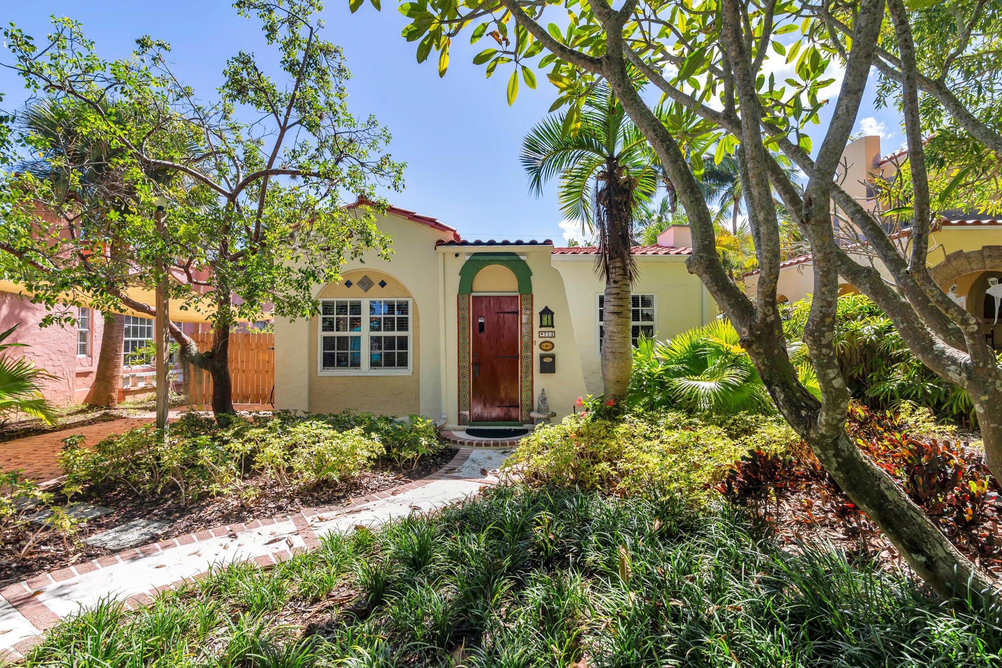 Step into a piece of history with this beautifully maintained 1920s home in West Palm Beach's desirable Flamingo Park Historic District. This residence perfectly blends classic charm, highlighted by Dade Pine hardwood floors and original details, with modern efficiency. The functional layout offers flexible spaces, including a formal dining room, charming breakfast room, and a versatile area that can serve as a third bedroom or a dedicated wellness space. This exceptional property also offers a one bedroom, one bath cottage, perfect for generating rental income, hosting guests, or creating a private home office/studio. You'll enjoy significant modern upgrades like electric solar panels and reverse osmosis water filtration system, along with the convenience of a carport