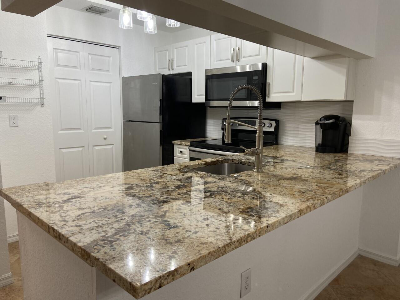 RENOVATED & STUNNING * Roomy 2 BR, 2 Baths condo with a great PB Gardens location * Granite in kitchen - counter top pass through made one level * SS appliances * Full tiled backsplash * New lighting * Granite vanity tops with vessel sinks in both bathrooms * Impact glass sliders and windows * Full size washer & dryer * Secure storage closet on same floor * Short walk to San Matera amenities including resort style pool, excellent fitness center, billiard room, indoor racquetball, sauna, lockers and more * A community with ample parking for residents and guests * Close to much shopping and dining including the Mall & Downtown at the Gardens * Easily access major roadways such as I-95, Florida Turnpike, and PGA Blvd. corridor * San Matera condo assoc. rules require minimum 630 credit score.
