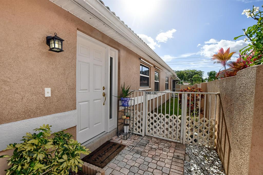 Don't miss the opportunity to live in a gated community in central Delray in the low $400's. This 2/2 villa with 2 car garage is located in the all ages, super PET friendly community of Palm Beach Bath & Tennis. The property is fully fenced making it perfect for pets, and has a screened in, covered patio. Throughout the entire house you will find gorgeous, brand new wood-look tile flooring. The living room has high volume ceilings, and there is an entirely separate laundry room with a new washer/dryer (2019), a sink, and TONS of extra storage. The kitchen has upgraded shaker cabinets and granite countertops, with all new appliances (2019). The ample master bedroom has a tray ceiling and a large walk-in closet.