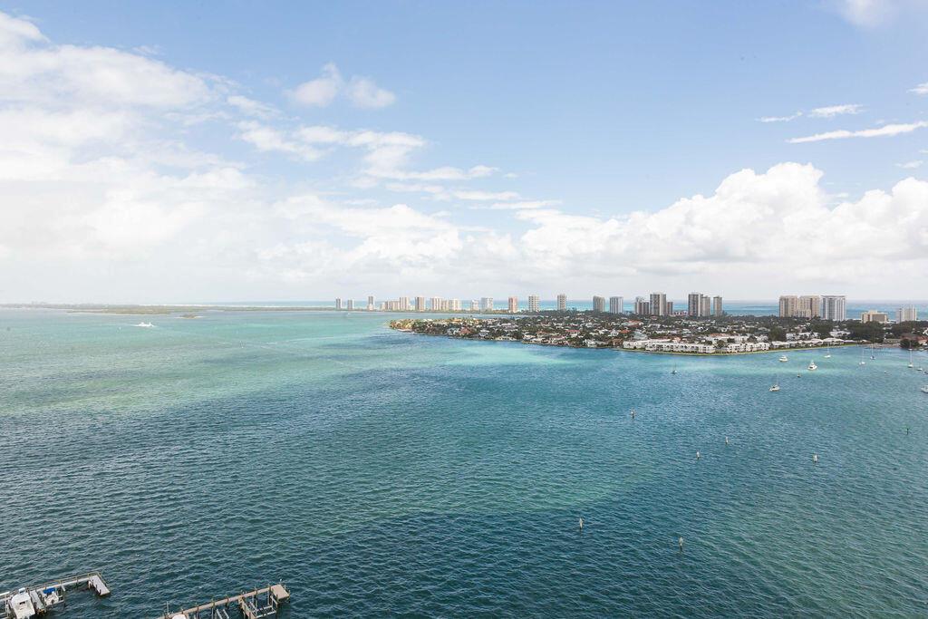One of a kind, beautiful expansive view of the everchanging ocean and intercoastal waterway. This 21st floor condo with 3 bedroom, 3-1/2 bath has a roomy, well-designed floor plan with a water view from each bedroom. Hurricane impact windows and floor-to-ceiling sliders open to a spacious private balcony. Authentic large light-colored marble floor tiles throughout. Recent kitchen upgrades include a new Calcutta quartz countertop with waterfall endcaps; beautiful white stone backsplash; a large, deep SS sink with a designer Rohl pulldown faucet; custom water purifying system for perfect drinking water; new Bosch appliances (induction cooktop, oven, microwave, and quiet dishwasher); KitchenAid French Door refrigerator; and a low noise heavy-duty garbage disposal. Other recent upgrades