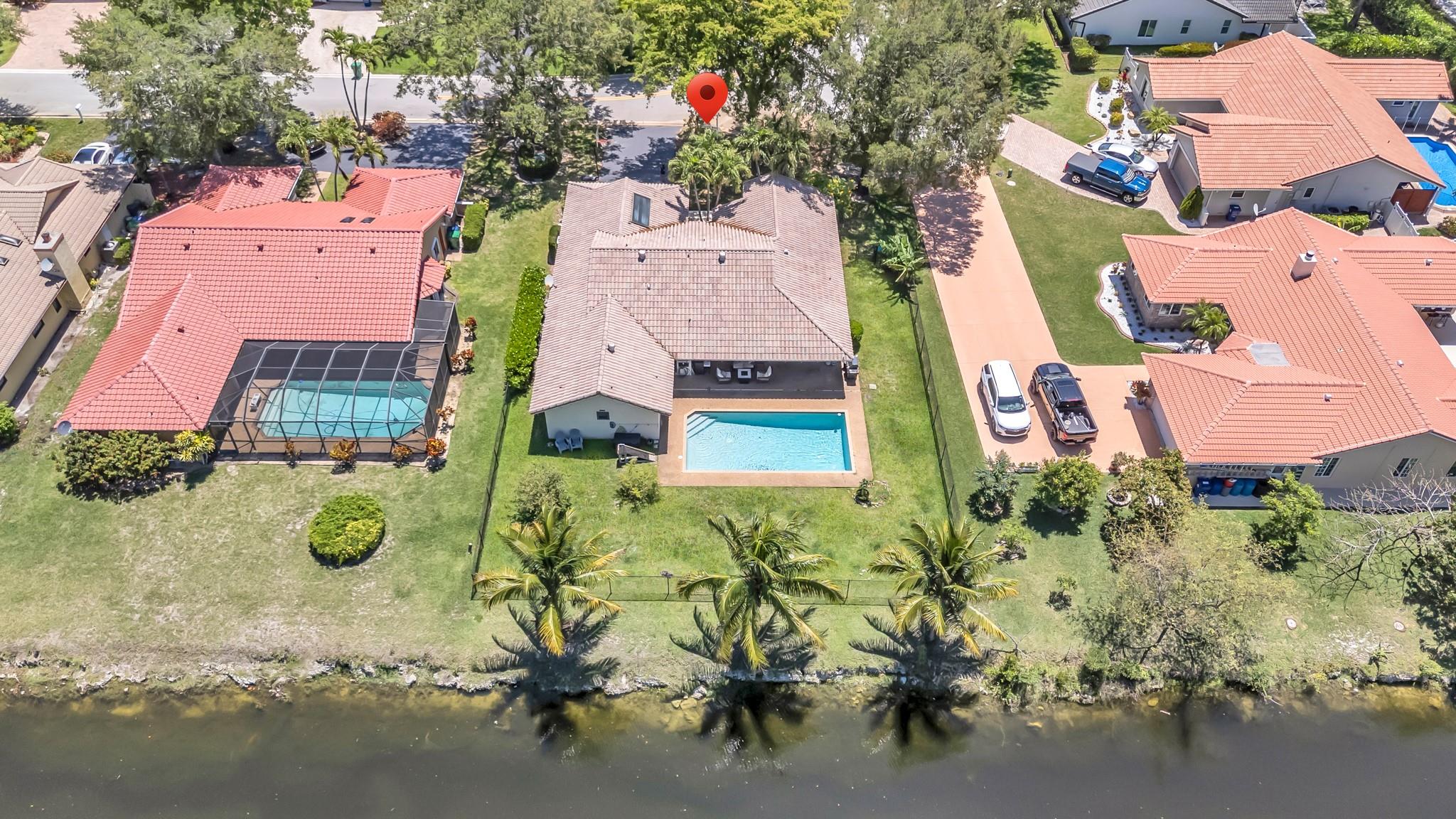 Submit all offers! Welcome to this fantastic 4-bedroom, 2.5-bath pool home, perfectly situated on a large water lot. With its impressive vaulted ceilings and well-designed layout, this property offers incredible potential for those looking to make it their own. While some renovations are needed, the home already boasts a living area with natural light, an open kitchen, a private dining area, plenty of room for entertaining and a huge fenced backyard with a pool, Newer AC, impact windows, and a brand-new water heater. Conveniently located near shopping, dining, and schools, this home is a rare find. Don’t miss the opportunity to transform this property into your dream home. Schedule your private showing today! Located near amazing restaurants and central to everything!
