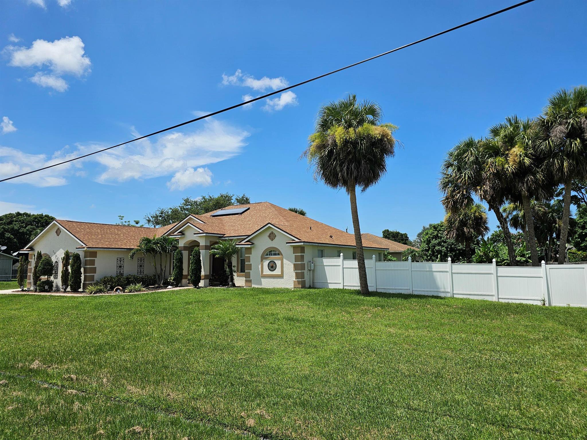 Stunning 4-Bed 3-bath home boasts a split floor plan & sits on a spacious WIDE 1/2 ACRES LOT, bring all your toys, Boat, RV, ADD a pool or a shed, entertain & host large family events. 2023 NEW ROOF, Fenced backyard. Embrace energy efficiency with owned/ no lease solar panels, 2022 solar W/H & a solar attic fan. 10ft ceilings, updated home, W/ Formal living & Dining Room, open concept. Relax in the remodeled primary bathroom. Enjoy year-round comfort with 2019 High Efficient A/C. Energy Star W&D W/warranty Included! Granite counter tops with 42in kitchen cabinets & stainless appliances with Double oven stove. Freshly painted w/bonus room. Minutes away to shopping, attractions, restaurants, the beach's, Tradition & highways. Offering $5000 for closing costs at asking price. Motivated Selle