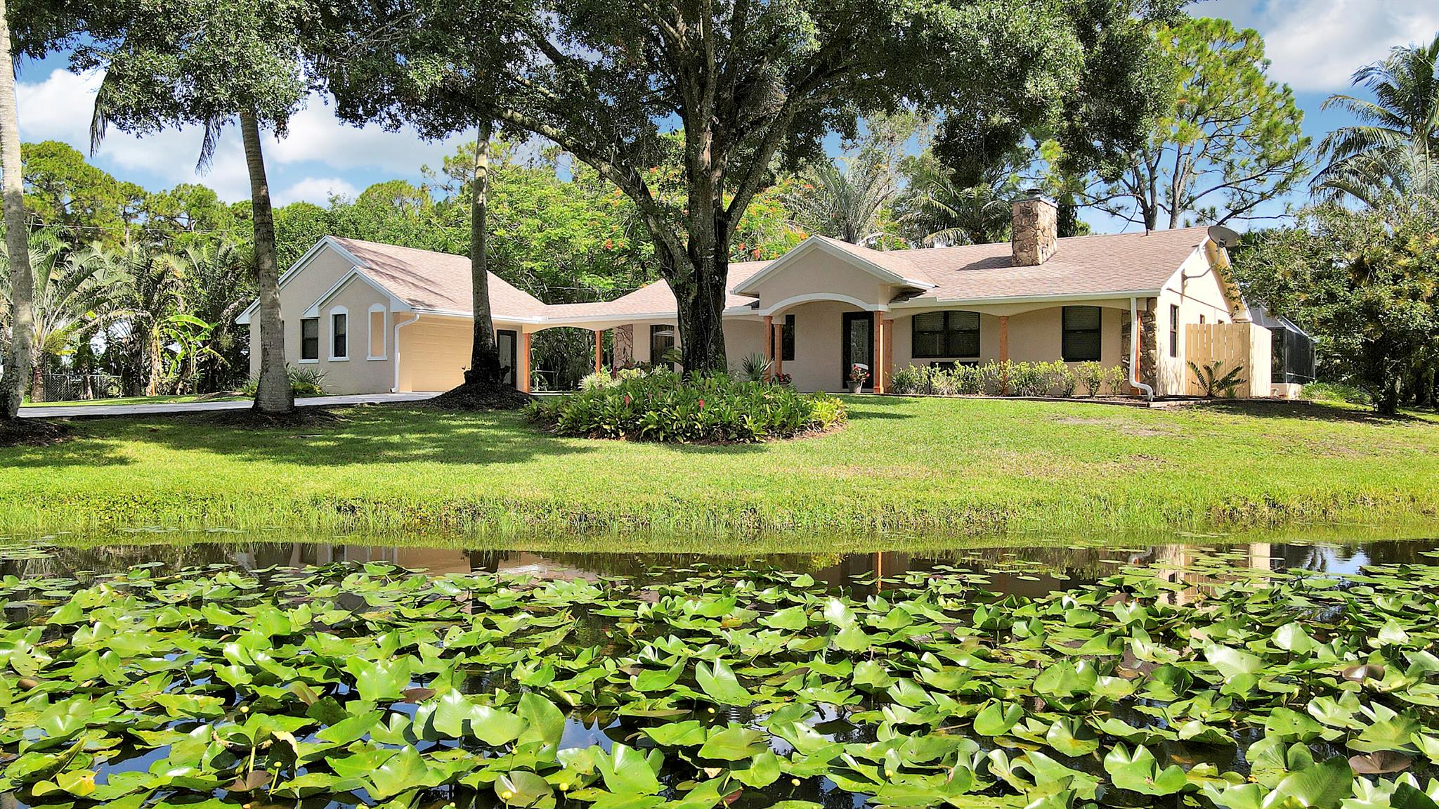 Renovated CBS Pool Home on 1.33 Acres - No HOA! Welcome to your private oasis in The Acreage! This beautifully updated 3-bedroom, 2-bath concrete block home sits at the end of a quiet, paved dead-end road. Featuring 1,926 sq ft of living space 2,625 total, the home offers a well-designed layout, impact windows, and a brand-new hot water heater. The tropical yard, complete with a pool, mature palm trees, and plenty of room to relax. Enjoy peace, privacy, and a welcoming community of great neighbors. Bring your boat, RV and toys!