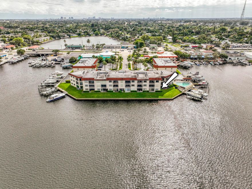 Wake up to panoramic Intracoastal views in this beautifully renovated 2BR/2BA ground-floor condo in the desirable Northlake Condos community in North Palm Beach. Thoughtfully updated throughout, this residence offers high-end finishes, a clean modern aesthetic, and direct water views. The interior features a custom floor-to-ceiling feature wall, and stylish flooring for a warm yet contemporary feel. The gourmet kitchen is outfitted with Frigidaire Gallery stainless steel appliances, modern cabinetry, designer quartz countertops with a waterfall edge, and under-cabinet lighting. Both bathrooms have been fully renovated with timeless tilework, floating vanities, and upscale finishes. The spacious primary suite offers walk-out water views, a generous walk-in closet, and a private en-suite bath. The second bedroom doubles as a flexible space, complete with a Murphy bed and glass French doors, perfect for guests, a home office, or a den. This home also includes in-unit laundry, a new A/C installed in 2024, and walk-out patio access where you can relax and enjoy boats passing by. Northlake Condos is a quiet, friendly, and well-maintained waterfront community, with manicured grounds, assigned parking, and a community pool overlooking the Intracoastal. Located just minutes from shopping, dining, golf, marinas, and beaches, and only a short drive to PGA Boulevard and Palm Beach Gardens.
