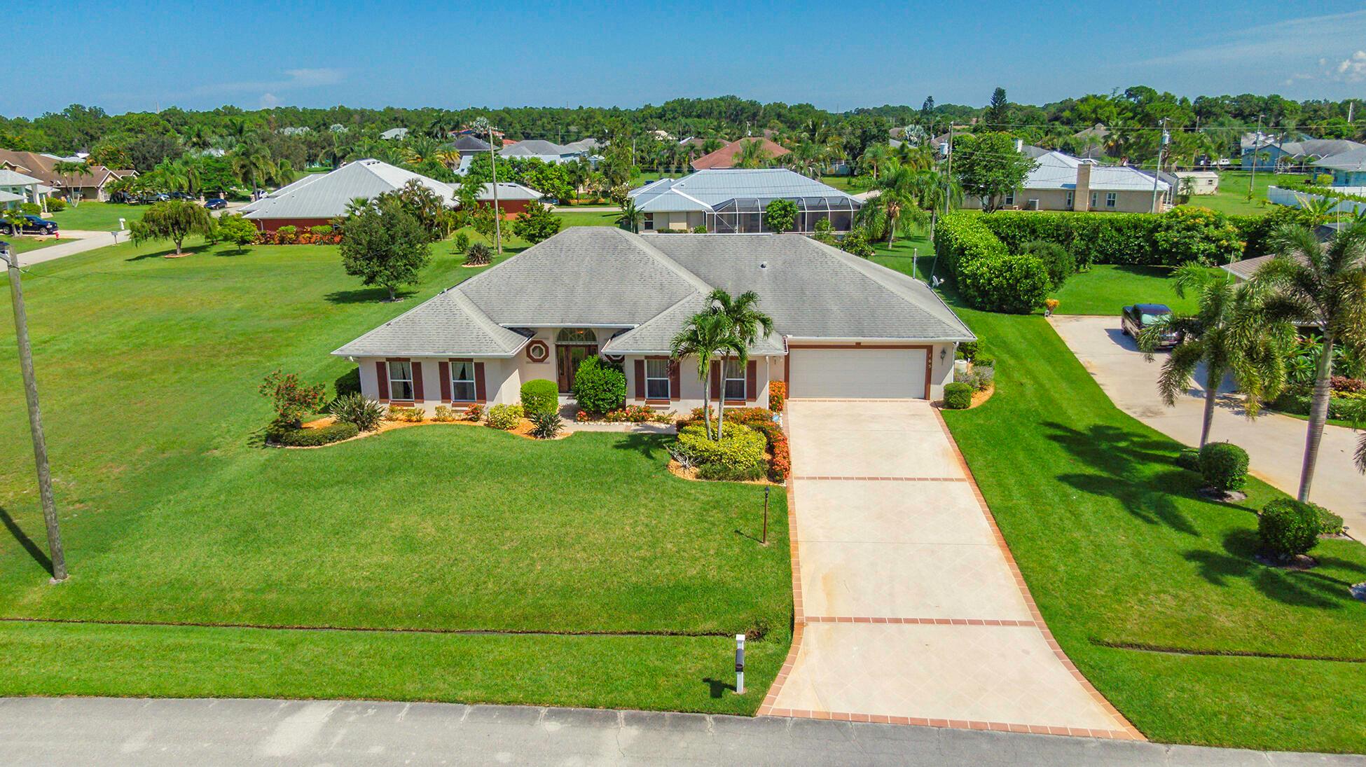 Welcome to your Florida retreat! This well-maintained 4 bed, 2.5 bath pool home with relaxing spa is just minutes from Port St Lucie's best shopping, dining, and the breathtaking beaches of Hutchinson Island. Set on a generously sized lot, this home offers a spacious layout, oversized garage with additional golf cart storage and full-house storm shutters. The large screened lanai is perfect for poolside gatherings or simply unwinding and soaking up the sun. Lovingly cared for, this home is move-in ready and just waiting for new owners to bring their personal touch and create lasting memories. Whether you're hosting friends or enjoying a quiet evening under the stars, this home offers the best of Florida living. Call today to schedule your tour! No HOA. Buyer to verify measurements.