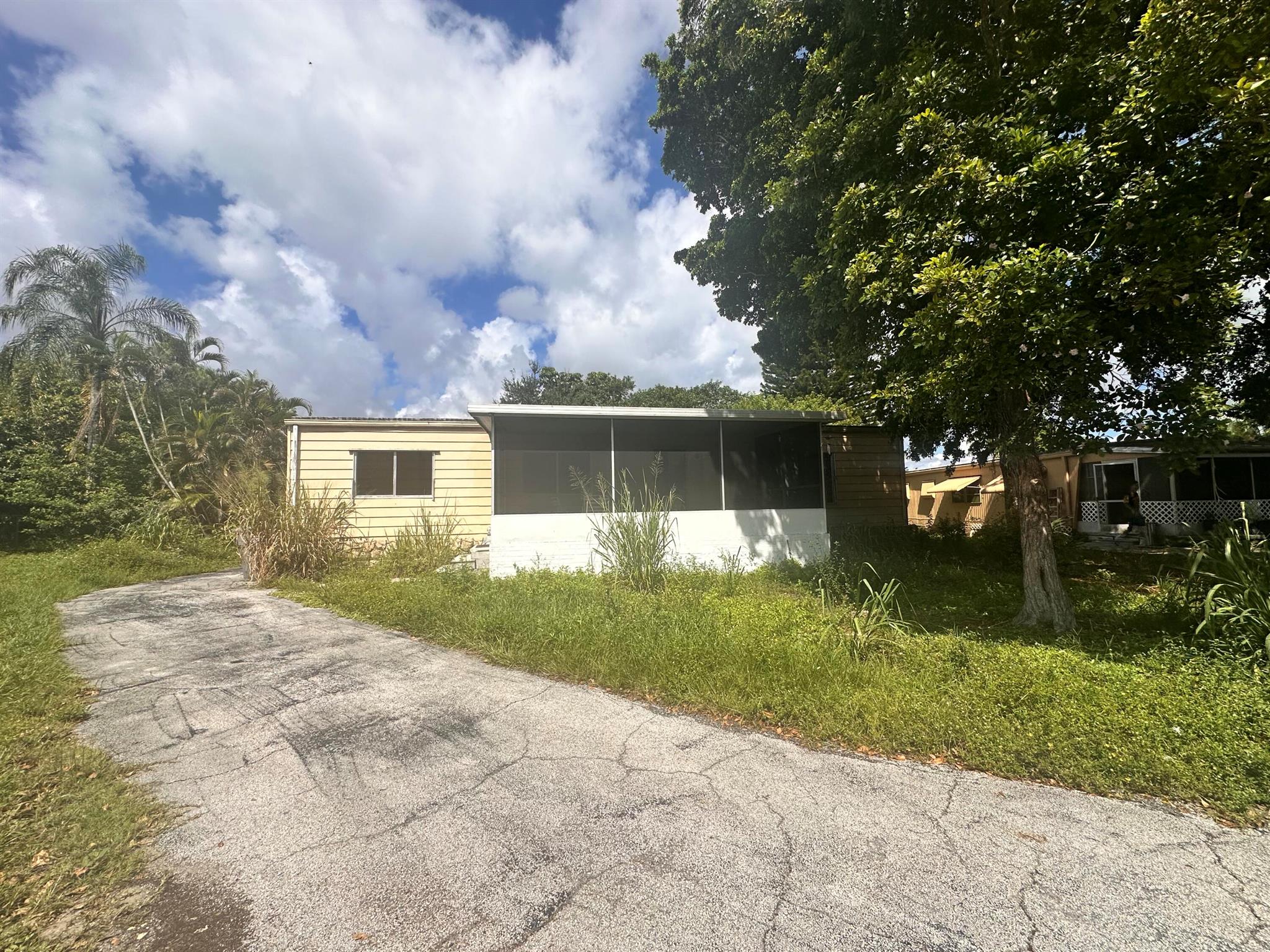 Welcome to 11898 Cove Pl in Watergate! This spacious mobile home offers 3 bedrooms and 2 upgraded bathrooms with a desirable split floor plan. The third bedroom can be used as a den, office, or guest room (no closet). Interior features include laminate and vinyl flooring, recessed lighting throughout, and an upgraded kitchen with granite countertops, white cabinets, and a stylish blue backsplash. A washer and dryer are included for your convenience. Enjoy relaxing on the screened front porch or entertaining in the open living space. Bathrooms have been updated. This home is ideally located just 1 mile west of 441, close to restaurants, bakeries, shops, and supermarkets. Landlord requests only first month's rent and security deposit.