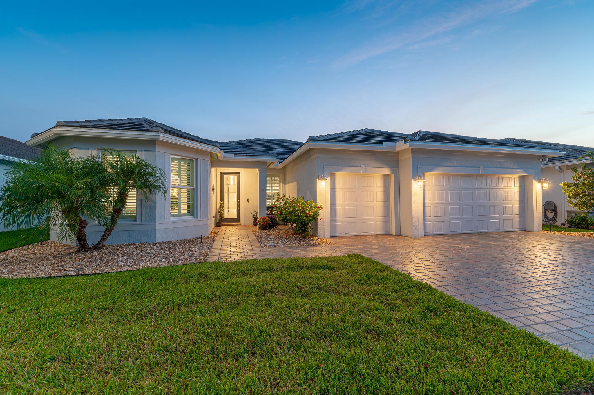 This exquisite home is an entertainer's dream, offering modern luxury, open-concept living, and stunning outdoor amenities. 3 bedrooms, a flex room, and 3 full baths offers space for everyone. The heart of the home is the custom chef's kitchen, showcasing a large island with upgraded granite countertops, stainless steel appliances, wall oven and microwave, gas range, and elegant white cabinetry. The open floor plan flows effortlessly into the bright and spacious family room, where ''zero corner'' sliding glass doors disappear to reveal a seamless transition to your outdoor oasis. Step outside to your covered and screened patio with a fully equipped summer kitchen, TV, and tranquil lake views. Additional highlights include a 3-car garage, whole house generator, and over $240,000 in upgrades