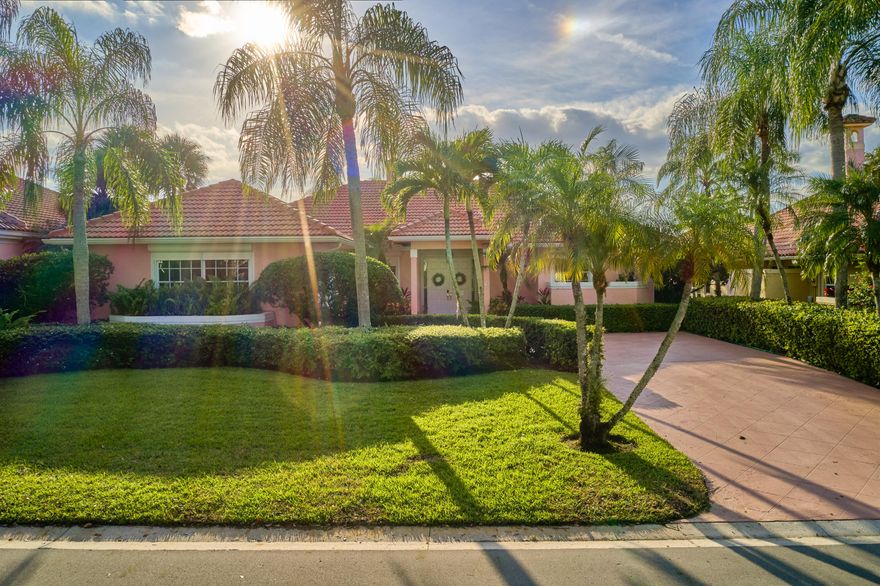 Welcome to this beautifully maintained one-story residence located in The Island at PGA National in Palm Beach Gardens. Offering 3 bedrooms, 3 bathrooms plus a dedicated office, this home features 2,620 square feet of living space under air on an expansive 11,474 square foot lot. Inside, stone-look tile flooring flows throughout the main living areas, complemented by warm-toned wood laminate in select spaces. Vaulted ceilings and an abundance of windows and sliding glass doors fill the living room, kitchen, and family room with natural light, creating an open and airy feel. A striking dual-sided mirrored fireplace serves as a central focal point, elegantly defining the living and dining areas. The kitchen is well-appointed with buttercream-toned wood cabinetry, dark granite countertops, and a full suite of black appliances, offering both functionality and charm. Step outside to the true highlight of the home - an expansive screened-in patio and pool area designed for effortless indoor-outdoor living. Multiple spaces for dining and lounging surround a sparkling pool with a corner waterfall feature, while a separate raised platform provides the perfect setting for sunbathing and relaxation. Enjoy tranquil views of the canal and preserve beyond. A built-in outdoor cabinet with sink and mini refrigerator adds to the convenience of this inviting space. Additional features include a 2016 roof, two A/C units (2019), and a new pool pump (2025). Storm protection is in place with panel shutters for the front door and electric shutters throughout the remainder of the home. Ideal for full-time living, seasonal use, or investment, this property offers comfort, functionality, and the best of Florida living in a sought-after community.