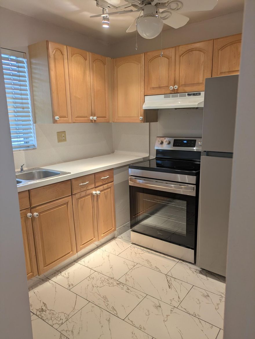Amazing investment opportunity or great to make your own home! All ages welcome. Brand new, gorgeous tiles throughout. Brand New stainless steel appliances, refinished counter tops. Conveniently located on the first floor, this condo features a spacious living areas and a bedroom big enough for a king bed. There is a half bath for guests. Enjoy a lovely courtyard view. The water heater was installed 1/2024, new AC in 7/2025. There is extra storage in the community storage room. On site laundry, one assigned parking space and plenty of guest parking.