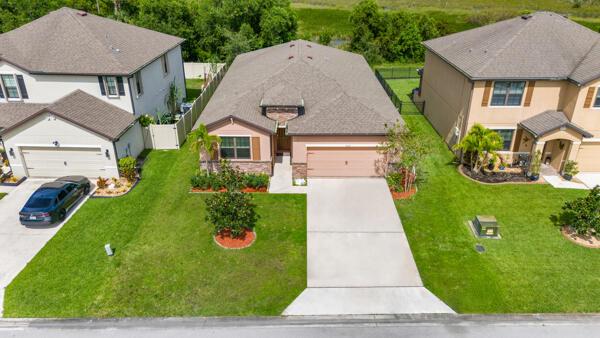 Freshly painted and upgraded with brand-new laminate floors (no carpet anywhere!), new ceiling fans. This 2019 energy-smart home in St. Andrews Preserve blends comfort with style. Inside, enjoy soaring 9′ ceilings, an open split-floorplan, and a covered back patio with tranquil preserve views. The kitchen shines with SS appliances, granite countertops, a subway-tile backsplash, and new kitchen faucet. Take advantage of resort-style amenities -- a state-of-the-art fitness center, sparkling pool, relaxing spa, and elegant clubhouse. Explore nearby treasures like the Oxbow Eco-Center, scenic trails, Nature Playscape. Minutes away With supermarkets, restaurants, fresh markets, and sun-kissed beaches just minutes away -- plus a quick commute to I-95 and US-1 -- this home checks every box.
