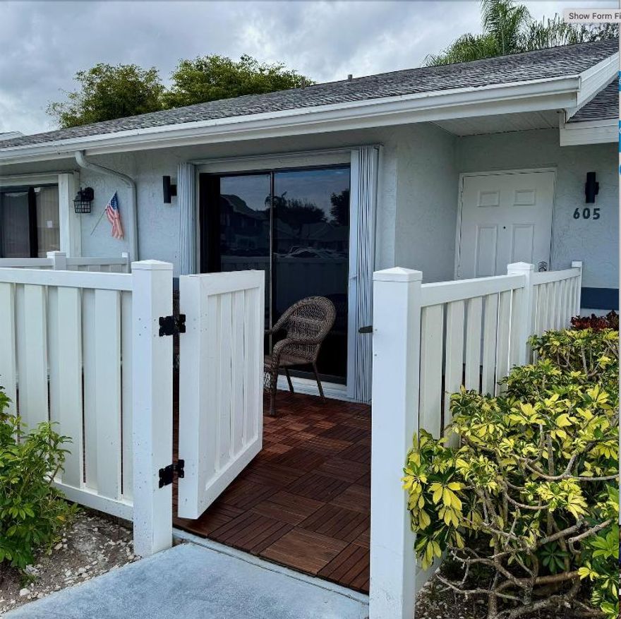 Step into comfort and style in this beautifully remodeled 2-bedroom, 2-bath villa located in the pet-friendly 55+ Arbours of the Palm Beaches (residents 18+ welcome). The home offers an open, airy layout with vaulted ceilings and tile and wood flooring throughout. Enjoy peaceful mornings in the private, fenced front courtyard with new acacia teak wood tile, and unwind in the enclosed porch for added living space. The bright, updated kitchen features white cabinetry, newer appliances, backsplash, pantry, and a cozy eat-in area. Both bathrooms have been thoughtfully renovated with modern vanities, anti-fog mirrors, bidet-equipped toilets, and whisper-quiet fans, creating a calm, spa-like feel.  The primary bath includes a jacuzzi tub, and the guest bath features a shower panel. Additional upgrades include keyless entry, USB and USB-C outlets, Nest thermostat, metal shutters and sensor lighting. Association fees include a newer 2022 roof, exterior maintenance, cable, internet, water, amenities, and more. Centrally located near shopping, dining, PBI Airport, parks, and major highwaysthis home offers easy, carefree Florida living.