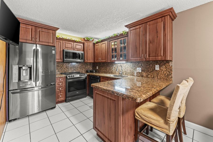 Welcome to this beautifully maintained and spacious 3BR/2.5BA townhome!Enjoy peace of mind with a new Aluminum roof, new AC, newer appliances, and a cozy gas fireplace. The inviting kitchen features stainless steel appliances and warm finishes that make cooking a delight.Upstairs, you'll find a primary suite and guest bedroom--each with its own private balcony--perfect for morning coffee or evening relaxation. All bathrooms include double sinks, with a convenient first-floor half bath and laundry room for added ease.Truly move-in ready, this home also offers a private patio and courtyard ideal for entertaining or quiet evenings outdoors. Ideally situated for both comfort and convenience, Perfectly positioned near schools, Palm Beach State College, the airport, and local hospital.