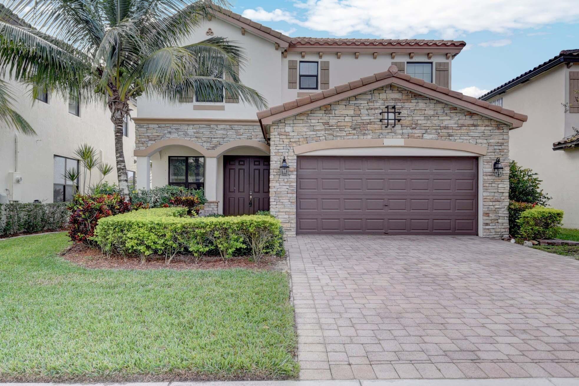 Fabulous garden-view home in a gated community near Wellington with quick access to Florida's Turnpike. Located in a great school zone! This 2-story, 5-bedroom, 3-bath residence welcomes you through a covered entry into living space featuring open and bright design and 9-foot ceilings in the Living and Family Rooms. The open-concept kitchen flows into a covered terrace, perfect for relaxing or entertaining. A spacious Family Room and a 1st-fl bedroom and full bath-ideal for guests and multi-generation family. Upstairs, Primary Suite has 2 large walk-in closets, a master bath with double sinks, a roman tub, and a glass-enclosed shower. Laundry room with washer and dryer is located on the 1st floor. Community Pool and Playground. HOA requires min Credit 720 for all occupants over age 18.