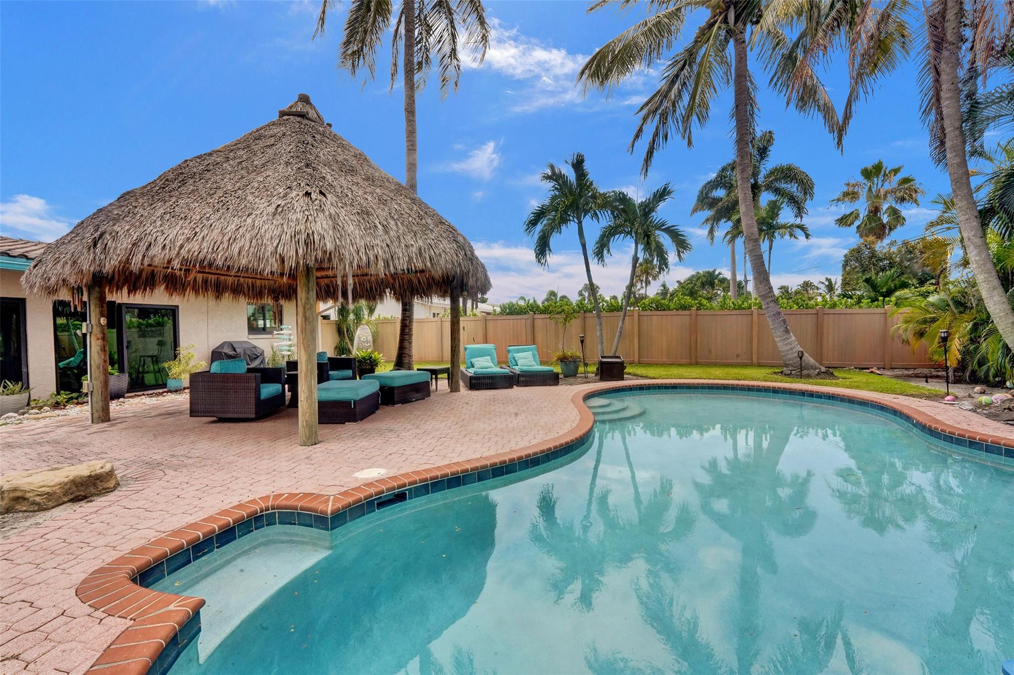 Escape to your own slice of paradise in Booming Pompano Beach! Updated Single-Family Pool Home located in the Garden Isles neighborhood. No HOA & no rental restrictions makes it ideal for Airbnb, a seasonal getaway, or full-time living. Just minutes from the beach, dining, and shops—with Publix and local restaurants within walking distance. The home features a spacious, open-concept layout, including an office/den, indoor laundry, and 1-car garage w/ paver driveway. Step outside to your private, tropical backyard complete with a freeform pool, large Tiki Hut w/ built-in TV & electric, and fully fenced yard perfect for entertaining. Additional highlights include hurricane-impact windows & sliders, and barrel tile roof. Invest now in Pompano Beach - South Florida's Fastest Growing City.