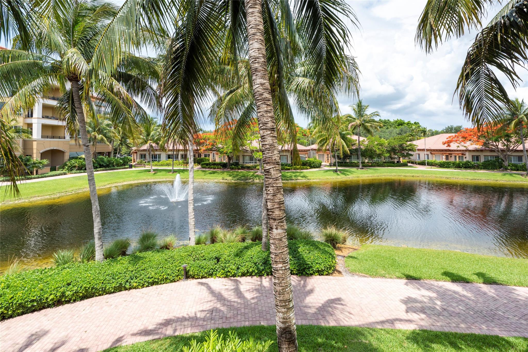 Water views all around. Stunning A model 2/2.5/Den with eat in kitchen in the most desirable Island House. Beautiful home with tons of upgrades, custom master closet. High impact windows & doors, large living area, spacious covered wrap around patio. Valet parking, Clubhouse, Fitness Center, Library,Resort style pool & spas, beauty salon, card room, full-service restaurant, Management & Medicare certified Home Health Care agency on site. Walkable to Publix, restaurants, minutes from Cleveland Clinic. Right to use storage available for purchase. $180/quarter restaurant credit, water, cable and internet included in maintenance. Furniture is negotiable. Must see!