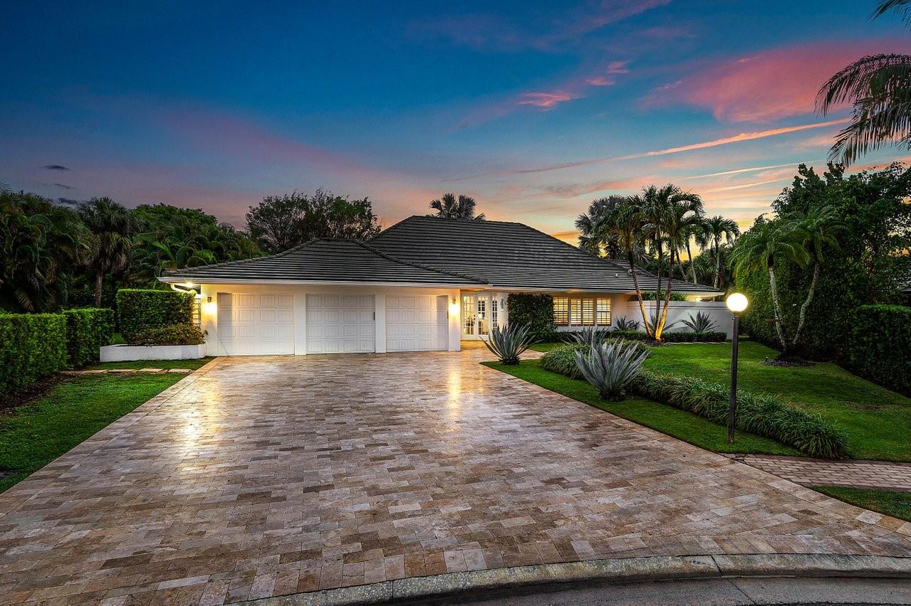 Tucked away on a quiet cul-de-sac in the prestigious St. Andrews Country Club, this beautifully updated one-story residence offers refined indoor-outdoor living with timeless charm. Vaulted ceilings and a wood-burning fireplace anchor the spacious main living area, creating warmth and character rarely found in modern renovations.  The interior of the home is drenched with natural light throughout, complete with impact windows and doors. The split floor plan includes four generous bedrooms, four full bathrooms, and a dedicated office, plus two main living areas for entertaining. The primary suite opens directly to a serene patio retreat—perfect for morning coffee or evening wind-downs.