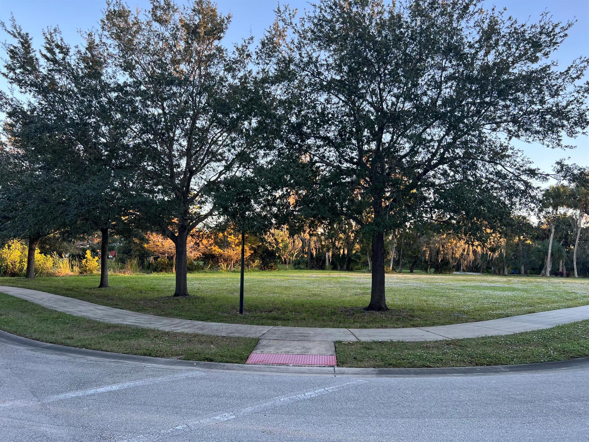 Owner will consider financing to qualified buyer! Magical Village of Kashi gated neighborhood. Rarely available, this tranquil and peaceful lot overlooks a nature pond with hiking trails to the community waterfront boardwalk and fishing pier. Serene is the best way to describe this beautiful corner lot property with surrounding oak trees and sidewalks. Flat, level, and ready to build. County water and sewer.