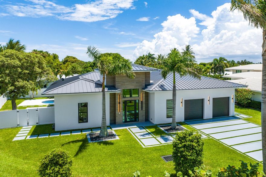 This stunning new home, brimming with character and sophistication, is now complete and ready for its first discerning owner. With soaring 12-foot ceilings and an open floor plan, this residence is designed for effortless entertaining. The chef's kitchen is a masterpiece, featuring rich wood tones, elegant creams, black and gold fixtures, Quartz countertops, and top-of-the-line Viking appliances, including a natural gas range. Designer touches, exquisite wall coverings, and custom built-ins add layers of character throughout.The indoor spaces transition seamlessly to the outdoors through expansive sliding doors that lead to the newly designed pool area and patio, perfect for al fresco living. Smart home features, including a Sonos sound system, a state-of-the-art alarm system,