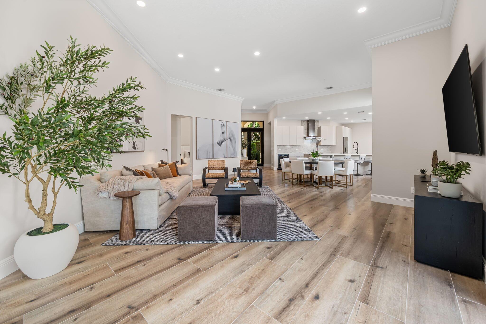 Welcome to this stunning, fully renovated residence located in the prestigious Palm Beach Polo & Country Club. Completely rebuilt from the studs up, this home offers the perfect blend of modern luxury and timeless design.Step inside to an open-concept layout featuring soaring ceilings with abundant natural light. The chef's kitchen is equipped with custom cabinetry, quartz countertops, premium stainless-steel appliances, and a spacious island ideal for entertaining.The elegant living and dining areas flow effortlessly to the newly added pool and beautifully landscaped outdoor space, creating a seamless indoor-outdoor living experience.