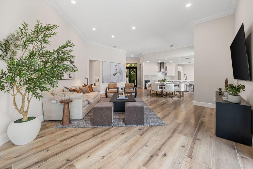 Welcome to this stunning, fully renovated residence located in the prestigious Palm Beach Polo & Country Club. Completely rebuilt from the studs up, this home offers the perfect blend of modern luxury and timeless design.Step inside to an open-concept layout featuring soaring ceilings with abundant natural light. The chef's kitchen is equipped with custom cabinetry, quartz countertops, premium stainless-steel appliances, and a spacious island ideal for entertaining.The elegant living and dining areas flow effortlessly to the newly added pool and beautifully landscaped outdoor space, creating a seamless indoor-outdoor living experience.
