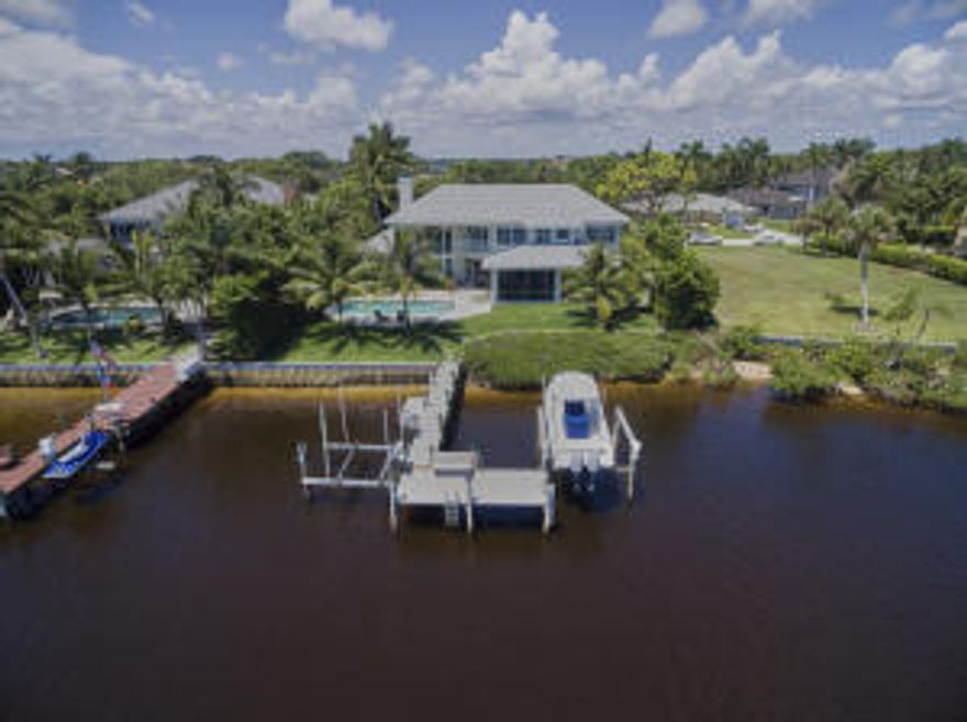 Nestled between the emerald green fairways of Tequesta Country Club and the serene waterways of the Loxahatchee River lay this exquisite riverfront estate perfectly situated in the highly sought after Anchorage Point in Tequesta. For those with discerning tastes and active lifestyles, you've found paradise. From the moment you walk through the front door, you are overwhelmed by breathtaking southeastern views of the Loxahatchee River, but when you tour this newly renovated 5 bedroom, 4 bath home, you realize that the endless views continue on from room to room. This beautifully renovated home was built in 1995 on 100 linear feet of pristine waterfront. The exterior boasts a new roof, 25ft resort styly pool with a covered & screened lanai for outdoor entertaining.