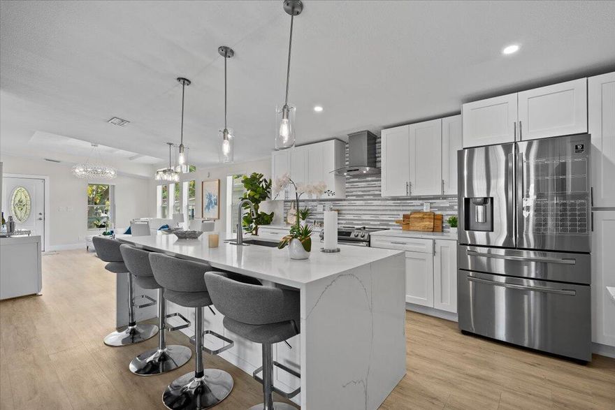 Beautifully renovated 3-bedroom, 2-bath home located in the highly desirable Meadows community in Palm Beach Gardens! This move-in-ready property features a stunning open-concept floor plan with luxury vinyl flooring throughout, a designer kitchen with quartz countertops, oversized island with seating, white shaker cabinetry, stainless steel appliances, wine cooler, modern backsplash, and upgraded lighting throughout. Spacious primary suite offers a private bath and generous closet space. Enjoy indoor/outdoor living with a covered front porch, paver driveway, attached carport, and private outdoor entertaining area perfect for relaxing or hosting guests. Meticulously maintained with updated finishes that give this home a true modern coastal feel. Conveniently located just minutes from I-95, The Gardens Mall, beaches, golf, shopping, dining, and Palm Beach International Airport.