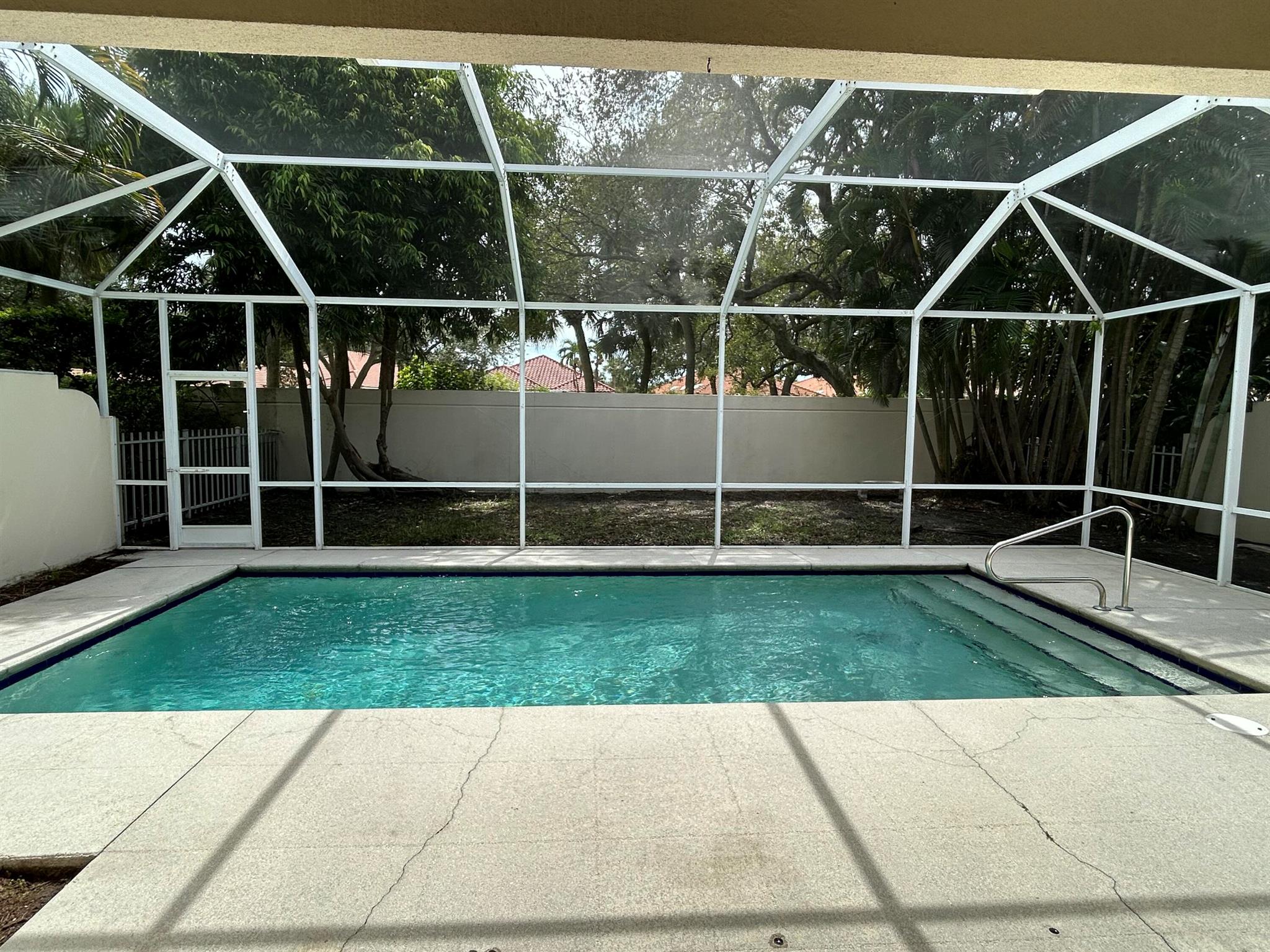 Oaks East is a guard gated community just south of the Gardens Mall. This property is a 1 story 3 Bedroom 2 bath 2 car garage . Granite kitchen counters; upgraded flooring; vaulted ceilings, wall of telescoping glass doors open to covered lanai and screened in resurfaced pool. Private quiet interior location.