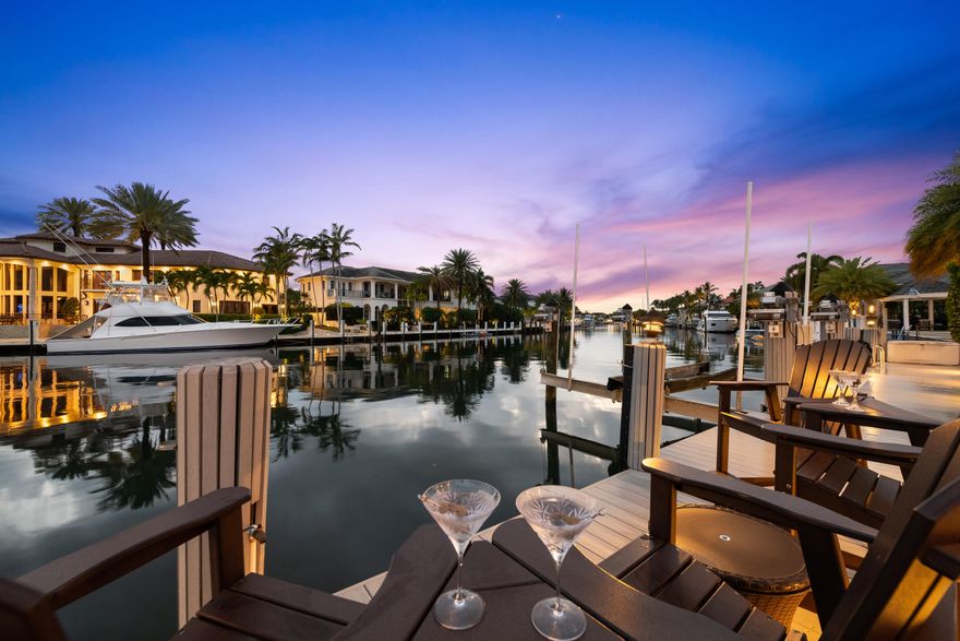 This beautifully designed 4-bedroom, 4-bath split-plan home offers 95 feet of deep-water frontage on a wide water canal with no fixed bridges, just minutes to the ocean. Perfectly positioned on the bend, the property features an 85-foot dock with boat lift, ideal for boating enthusiasts.  Inside, natural light pours through impact windows, highlighting a spacious, open layout designed for both comfort and entertaining. The home includes a dedicated office, wet bar, and a serene primary suite with sitting area and spa-style bath. Step outside to your resort-style backyard, complete with a newer heated pool and spa, lush landscaping, and stunning water views—creating the ultimate South Florida lifestyle. Additional upgrades include a NEW whole-house generator, NEW 2 AC systems, and fully integrated speakers for entire home. Plus much more!  A rare opportunity to own a true waterfront gem in one of Lighthouse Point's most sought-after neighborhoods. A MUST SEE!