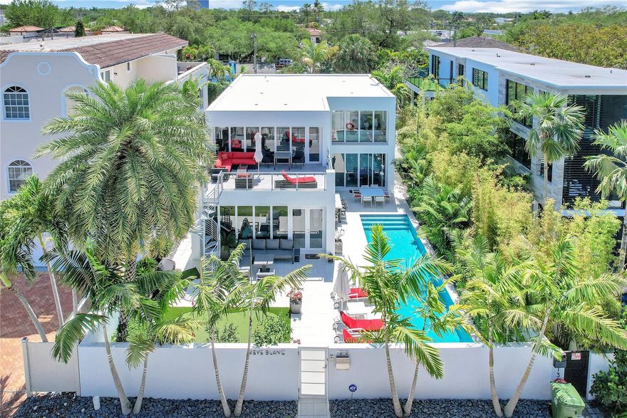 Exclusive Contemporary Home in Fort Lauderdale's desirable Colee Hammock! Close to vibrant Downtown, this home offers the perfect mix of luxury and location. Designed as a spa-like retreat, it features a heated saltwater lap pool surrounded by a privacy-enhancing fence. The two-story layout includes a sleek kitchen with stone countertops, Viking gas cooktop, three Miele ovens, built-in espresso machine, and wine cooler. The spacious primary suite offers a walk-in closet and private terrace, while three junior suites have en-suite baths. Upgrades include smart lighting, home automation, dual HVAC, and a gas generator. Outdoor features include a Napoleon BBQ, gas fire pit, audio system, and resurfaced decks. Move-in-ready with fresh paint and a new TPO roof!