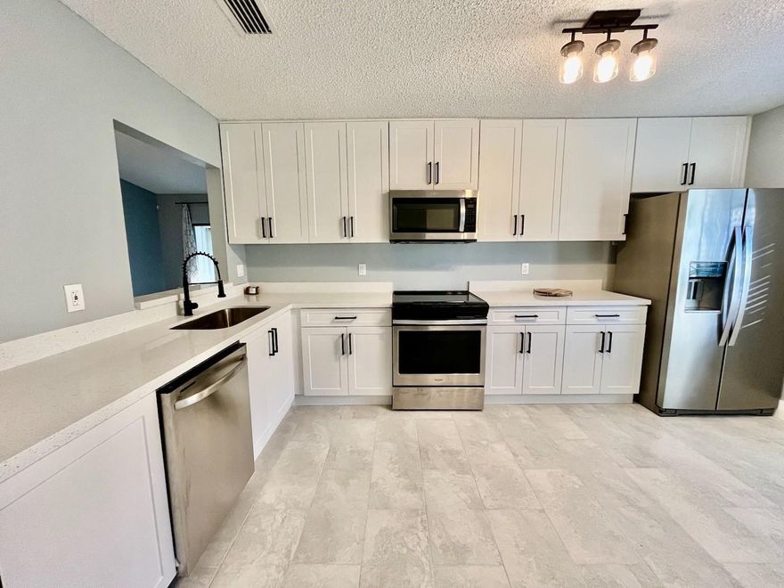 Large, fully upgraded three bedroom, two bath corner townhome in well maintained gated community. Property features lake view with private screened in patio, hurricane shutters and one car garage. New kitchen cabinets and  bathroom vanities and full size washer/dryer. Glass enclosed showers and all new vinyl flooring and fixtures. HOA includes landscaping, water/trash, gym, two community pools, tennis courts, clubhouse access and cable tv.