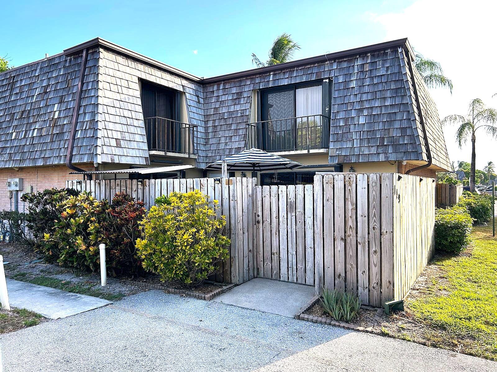 This is a well-maintained townhome with upgraded kitchen and bathrooms is located in the quiet neighborhood of Lakewood. Enjoy the private, fenced courtyard - excellent for entertaining or relaxing. It includes a built-in grill area and a nicely-built storage space. Convenient access to two designated parking spaces right outside the unit.Have peace of mind with new A/C, W/H, kitchen appliances and water softener (all less than a year old). Tiles throughout, granite counter tops, and backsplash in kitchen and upstair bathroom. Plenty of natural light from all four sliding glass doors on both floors. Enjoy a cool evening from one of the balconies on each of the bedrooms. This home is move-in ready and conveniently located - close to amenities, dining, entertaining and the beach!