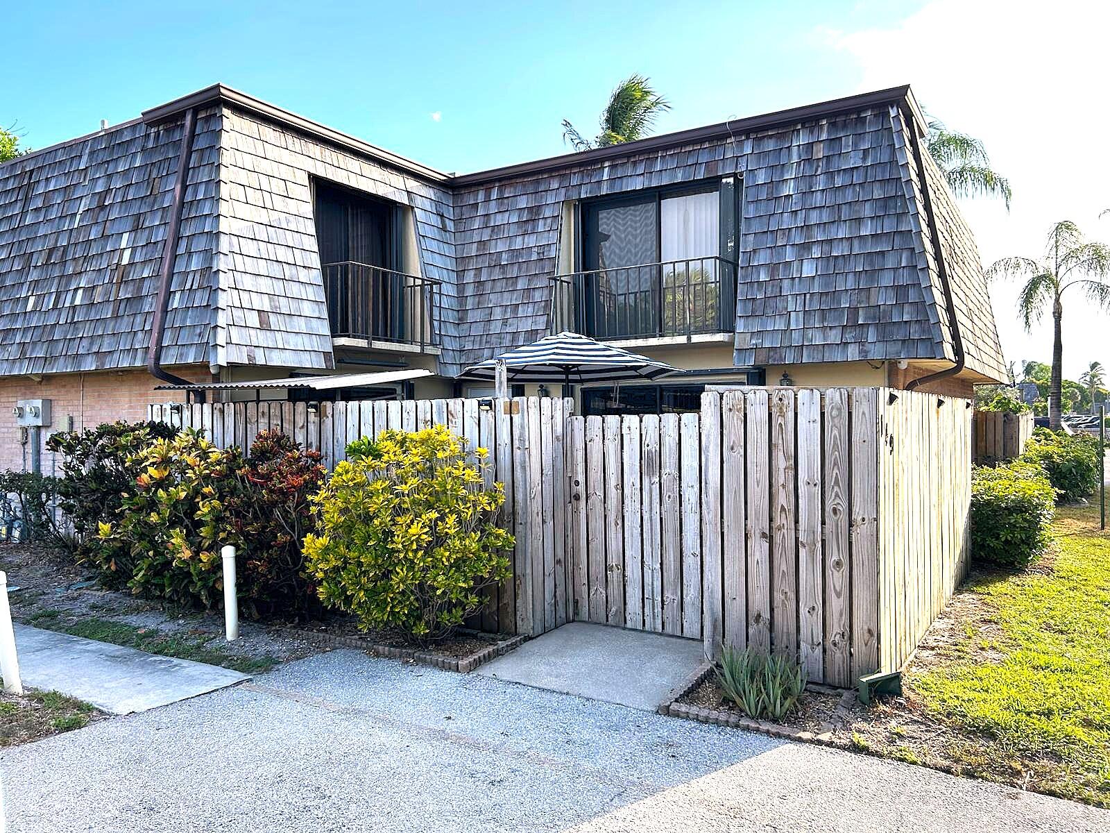 This is a well-maintained townhome with upgraded kitchen and bathrooms is located in the quiet neighborhood of Lakewood. Enjoy the private, fenced courtyard - excellent for entertaining or relaxing. It includes a built-in grill area and a nicely-built storage space. Convenient access to two designated parking spaces right outside the unit.Have peace of mind with new A/C, W/H, kitchen appliances and water softener (all less than a year old). Tiles throughout, granite counter tops, and backsplash in kitchen and upstair bathroom. Plenty of natural light from all four sliding glass doors on both floors. Enjoy a cool evening from one of the balconies on each of the bedrooms. This home is move-in ready and conveniently located - close to amenities, dining, entertaining and the beach!