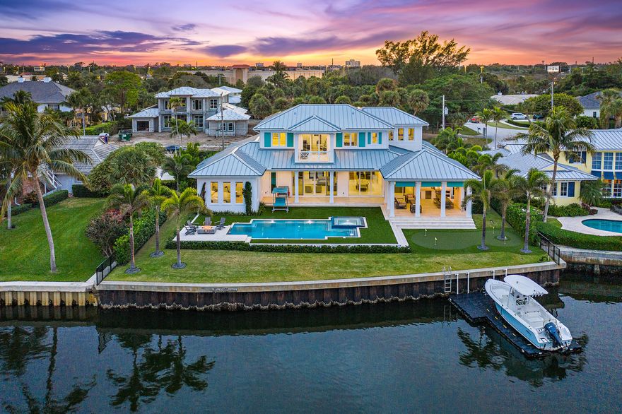 This British West Indies estate in Hidden Key offers the finest in family living with deep water access, and close proximity to the best area schools, restaurants, shops and clubs.  Built in 2019, this ''light and bright'' home has a wall of glass sliders across the great room and kitchen to highlight the pool and patio areas, and endless views of Little Lake Worth.  The first floor features the master suite, office, great room with open kitchen, mud room, laundry room, wine storage area under the stairs, and three- car garage.  Just off the kitchen is the rear covered patio with a summer kitchen and cabana bath.  Just beyond the pool and spa is a relaxing firepit retreat overlooking the water.  The second floor has three guest bedrooms en-suite, plus another office.  All rooms on the second floor were designed to take advantage of the water views.  Among the special features of this property is a stand-by generator, impact glass windows and doors, floating dock, putting green, lighting control system, electric shades, and much more.