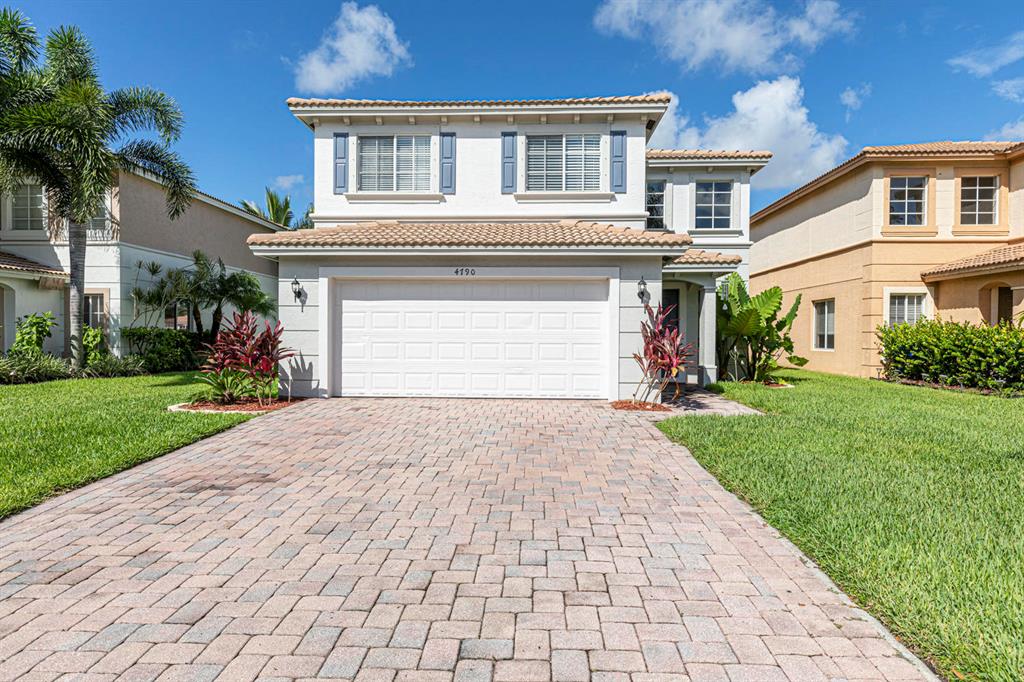 TURN KEY, move in ready! This stunning home looks every bit of the pictures you see here. Walking in the home you immediately are drawn to the open feel of a 20' volume ceiling that captures light all day making it always bright inside. This home has upgraded floors thru-out, decorative lighting, custom window treatments & new tropical landscaping outside. Newer Stainless steel appliances welcome you in your kitchen as well as a BRAND NEW washer & dryer located in a separate ''closed-in'' laundry room. Kitchen has a quaint breakfast nook & high bar that has a direct view of the large BRAND NEW FULLY fenced in backyard overlooking the lake which faces west, to give you a gorgeous sunset to end every day with. Master bedroom over looks the lake as well & has his & hers walk in closet.