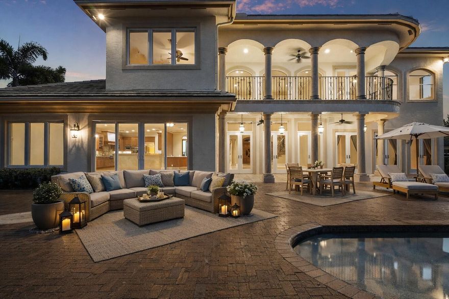 Your next home is a Magnificent Estate nestled in the prestigious gated community of Pine Tree Golf Club. This 5-bedroom, 4.1-bath Mediterranean masterpiece sits on almost 1/2 acre and is lushly landscaped to perfection! Enter to soaring ceilings, expansive floor-to-ceiling glass, and refined craftsmanship throughout. Quality construction and decor featuring Elegant stone and marble finishes, solid wood doors, and dramatic architectural details. Multiple living and entertaining spaces flow seamlessly to the outdoors, where covered patios and a resort-style pool setting invite true indoor-outdoor living. The thoughtfully designed layout includes a grand great room with vaulted ceilings & walls of glass, a regal formal living room, formal dining room, family room, and den. The kitchen is well-appointed with custom solid wood cabinetry, distinctive stone surfaces, artistic backsplash detailing, dual sinks, and stainless steel appliances, including a gas cooktop ideal for both daily living and entertaining. A built-in bar adds to the home's effortless hosting appeal. Upstairs, the primary bedroom suite has sweeping views and a spa inspired bath with Steam Shower and frameless glass enclosure. Recent updates include a 2025 roof, multi-zone air-conditioning systems, full LED lighting throughout, exterior paint and lighting, updated plumbing fixtures and disposals. The outdoor amenities have also been improved with a newer pool heat pump, pool filter housing, and automatic pool fill system. Additional features: Impact Windows and Doors, Whole House Generator, Security system, Irrigation system, fenced yard, and an attached 3-car garage. Very close to the Famous "Atlantic Ave" boasting world-class dining, shopping, and entertainment! This estate delivers privacy, quality, and understated luxury for the discerning buyer. Some photos virtually staged.