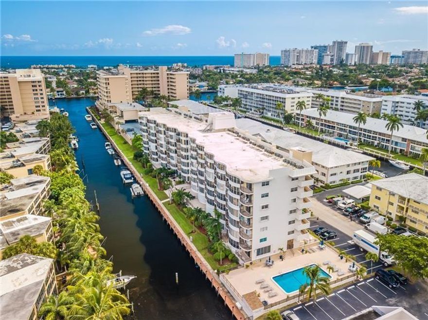 WOW OCEAN ACCESS & GREAT LOCATION !! 2 BEDROOM 2  BATH EAST OF BAYVIEW DRIVE SOUTH OF COMMERCIAL ! CORAL RIDGE COUNTRY CLUB AREA *1450 SQ FT,  GORGEOUS WATERWAY VIEWS. UPGRADED KITCHEN & BEAUTIFUL BATHS,  TILE FLOORING THROUGHOUT, SPLIT BEDROOM & STACKABLE WASHER & DRYER IN UNIT, CUSTOM CLOSETS & MUCH MORE.  OPEN LIVING/ KITCHEN DESIGN + SECURED UNDER BUILDING GARAGE  PARKING  STORAGE, COMPLETE HURRICANE IMPACT WINDOWS & SLIDER,  HEATED POOL , BOAT DOCKAGE FOR PURCHASE UPON AVAILABILITY. ASK FOR MORE INTEL, WALK TO BEACH , RESTAURANTS & SHOPPING *UPDATED ELEVATORS & LOBBY GREAT POOL AREA