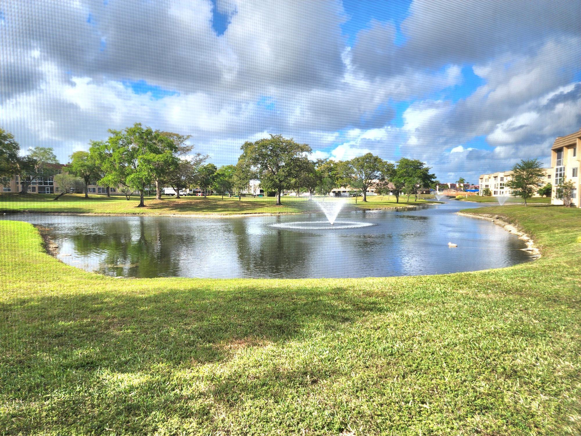 Spacious 1st floor-2-bed, 2-bath lake-view unit in a beautifully maintained 55+ community. This quiet retreat comes fully furnished (excluding personal items) with tile and carpet throughout. The AC and appliances are just 3–4 years old. Enjoy resort-style amenities, including golf, heated pools, tennis, shuffleboard, a clubhouse, a theater, a gym, and more. Roll-down shutters on the patio and extra refrigerator. No rentals allowed. Financing requires 20% down, cash 10%, and a $3,250 income requirement. All buyers must be 55+, with a 6-month escrow maintenance deposit held for two years. See MLS for details. Unit is sold "AS IS" with right to inspection.