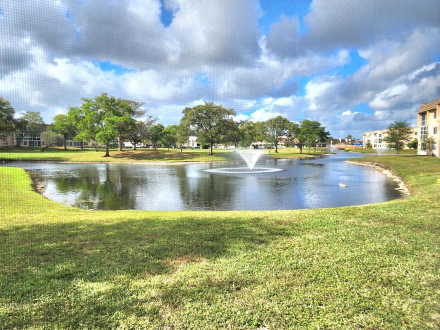 Spacious 1st floor-2-bed, 2-bath lake-view unit in a beautifully maintained 55+ community. This quiet retreat comes fully furnished (excluding personal items) with tile and carpet throughout. The AC and appliances are just 3–4 years old. Enjoy resort-style amenities, including golf, heated pools, tennis, shuffleboard, a clubhouse, a theater, a gym, and more. Roll-down shutters on the patio and extra refrigerator.  No rentals allowed. Financing requires 20% down, cash 10%, and a $3,250 income requirement. All buyers must be 55+, with a 6-month escrow maintenance deposit held for two years. See MLS for details. Unit is sold "AS IS" with right to inspection.