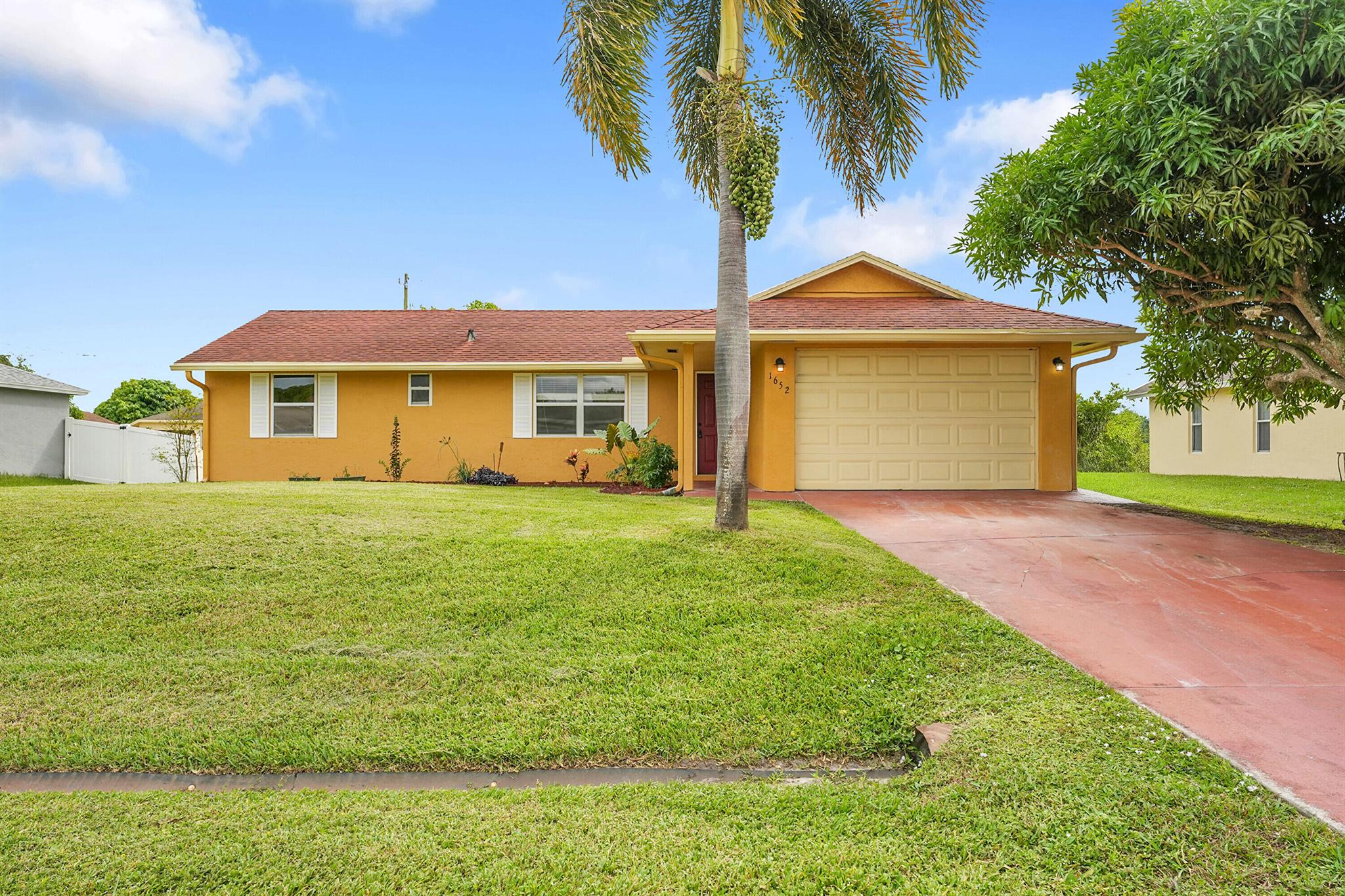 Welcome to your new home a beautifully maintained 3 bedroom, 2 bathroom residence with a spacious garage and an oversized back yard that is a gardener's dream! You will love the abundance of fruit trees offering a private oasis right in your own yard. Located off Rosser south of Gatlin this home sits in one of the most desirable areas in Port St Lucie, Just minutes from Tradition, shopping, dining, parks, and I-95 for easy commuting. Step inside and you will find a bright open floorplan that's completely move-in ready perfect for anyone looking for a low maintenance Florida lifestyle. Homes like this don't come around often and they don't last long. Schedule your private showing today before it's gone!