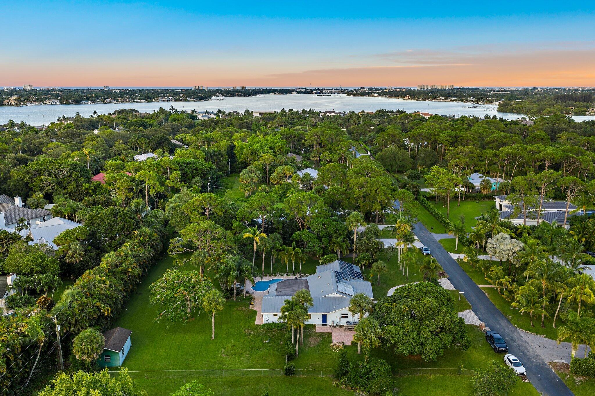 Rare opportunity in one of Jupiter's most established and sought after neighborhoods.Located in Pennock Point with no HOA this 1.1 acre property offers flexibility and long term value in a location surrounded by some of Jupiter's most impressive waterfront homes.Built as part of a 2003 addition, the CBS construction with full impact windows gives you a solid starting point to make into your dream home or reimagine with a custom rebuild. The home spans 3,163 sq ft with 4 bedrooms plus office, 3 bathrooms, a split floor plan, a large primary suite with oversized bath and closet and extra storage room.Additional features include an attached 2 car garage, detached 1 car garage, circular driveway with extended pad for boat or RV storage, central vac, high end cabinetry, newer