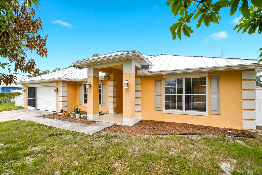 Photo of 1692 SW Lofgren Avenue, Port Saint Lucie, FL 34953 (MLS # B26039913)