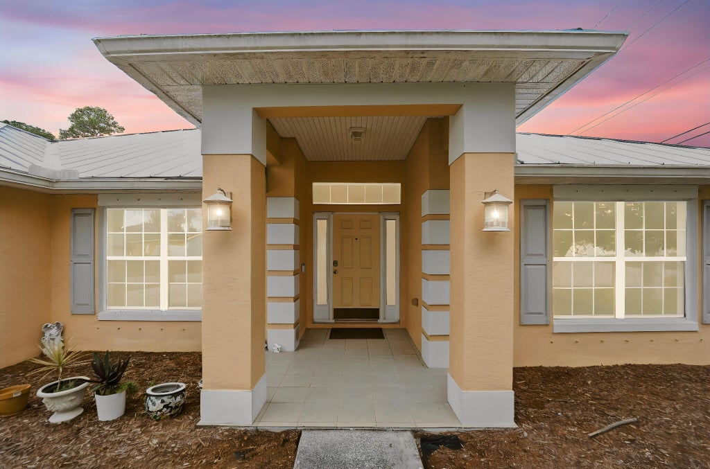 Photo of 1692 SW Lofgren Avenue, Port Saint Lucie, FL 34953 (MLS # B26039913)