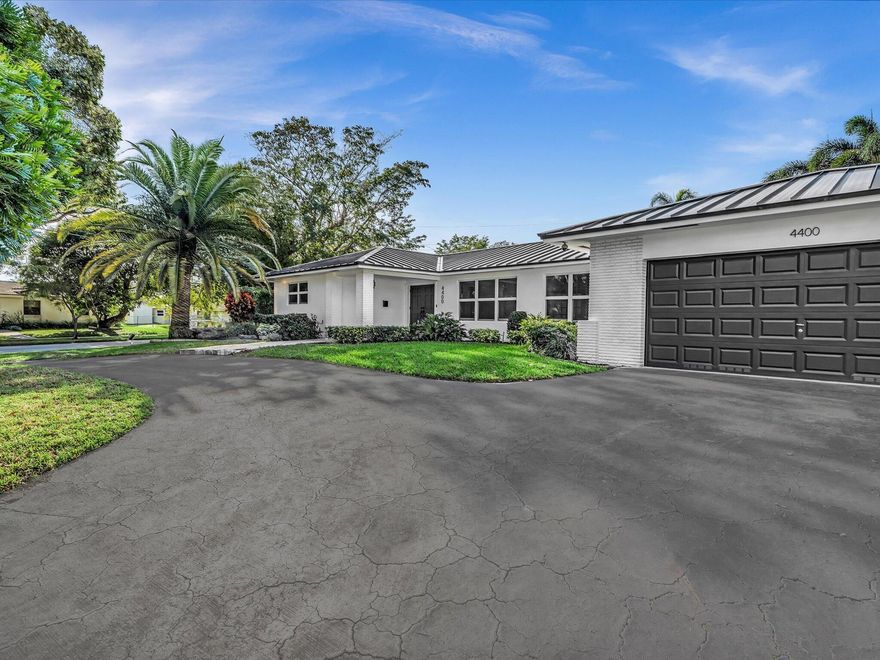 Beautifully updated and exceptionally rare 5BD/4BA residence on one of the largest lots in the neighboorhood, with nearly 3K SF of interior living space plus an oversided garage. Rest easy with a new 50-year metal roof, new PVC plumbing, full impact windows, freshly painted, and brand new tile flooring being installed. The interior showcases expansive open living spaces, highlighted by a dramatic brick fireplace and abundant natural light. Multiple living and dining zones flow seamlessly into the large kitchen and out to the backyard, creating the perfect space for living and entertaining. Step outside to a resort-style backyard with a large pool and spacious deck areas. Walking distance to houses of worship and close to top dining, entertainment, and beaches, this home has it all.